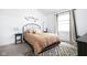 Bright bedroom featuring a queen bed with a black iron frame and minimalist decor at 8753 Champions Dr, Indianapolis, IN 46256