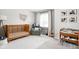 Charming Bedroom featuring a wooden crib, cozy chair, and natural light at 8753 Champions Dr, Indianapolis, IN 46256