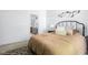 Bedroom showcasing neutral tones, a queen-sized bed, and an adjacent bathroom at 8753 Champions Dr, Indianapolis, IN 46256