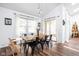 Open dining room with wooden table, stylish chairs, and sliding door access at 8753 Champions Dr, Indianapolis, IN 46256