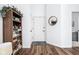 Bright entryway with wood floors, white walls, and stylish decor at 8753 Champions Dr, Indianapolis, IN 46256