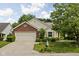 Charming single-Gathering home with brick accents, attached garage and mature landscaping at 8753 Champions Dr, Indianapolis, IN 46256