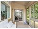 Bright sun room featuring decorative throw pillows, a sliding glass door and multiple windows with backyard views at 8753 Champions Dr, Indianapolis, IN 46256