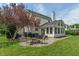 Expansive backyard with a patio, fire pit, grill, and sunroom addition, ideal for entertaining at 8904 Carnation Dr, Noblesville, IN 46060