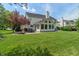 Lush backyard features a stone patio, grill, fire pit, and sunroom, perfect for outdoor gatherings at 8904 Carnation Dr, Noblesville, IN 46060