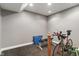 Basement gym area with a road bike and equipment, white walls, and black flooring at 8904 Carnation Dr, Noblesville, IN 46060