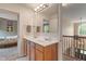 Bathroom featuring dual sinks, wood cabinets, with an attached bedroom at 8904 Carnation Dr, Noblesville, IN 46060