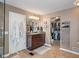 Spacious bathroom featuring tile flooring, vanity with sink, and a walk-in closet at 8904 Carnation Dr, Noblesville, IN 46060