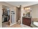 Bathroom featuring tile flooring, vanity with sink, toilet, and a walk-in closet at 8904 Carnation Dr, Noblesville, IN 46060