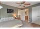 View of carpeted bedroom with a ceiling fan, an open door to a bathroom, and closet doors at 8904 Carnation Dr, Noblesville, IN 46060