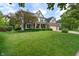 Beautiful two-story home with a well-manicured lawn, mature trees, brick facade, and a three-car garage at 8904 Carnation Dr, Noblesville, IN 46060