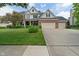 Charming two-story brick and white home with a well-manicured lawn and a three-car garage at 8904 Carnation Dr, Noblesville, IN 46060