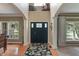 Grand two-story foyer with wood flooring, large windows, and elegant architectural details at 8904 Carnation Dr, Noblesville, IN 46060