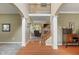 Welcoming foyer featuring hardwood floors, an open staircase, and views into the living areas at 8904 Carnation Dr, Noblesville, IN 46060