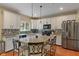 Well-lit kitchen featuring granite countertops, stainless steel appliances, and a center island at 8904 Carnation Dr, Noblesville, IN 46060