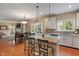 Spacious kitchen with an island, granite countertops, stainless appliances, and access to the dining area at 8904 Carnation Dr, Noblesville, IN 46060