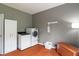 Laundry room featuring new white washer and dryer, wood floors, and ample storage cabinets at 8904 Carnation Dr, Noblesville, IN 46060