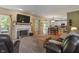 Bright living room with fireplace and an open floorplan flowing into the kitchen and dining area at 8904 Carnation Dr, Noblesville, IN 46060