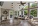 Bright sunroom with a vaulted ceiling, ceiling fan, neutral decor, and sliding glass doors leading to the outdoors at 8904 Carnation Dr, Noblesville, IN 46060