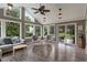 Inviting sunroom featuring tile floors, neutral decor, bright lighting, and sliding glass doors to the backyard at 8904 Carnation Dr, Noblesville, IN 46060