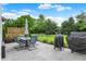 Outdoor patio set with umbrella, well-maintained lawn and garden beds in this backyard at 9653 Cypress Way, Carmel, IN 46032
