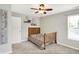 This bedroom features a wooden bedframe, light gray walls, and a ceiling fan at 9653 Cypress Way, Carmel, IN 46032