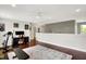 Spacious bonus room with wood floors, ceiling fan, and exercise equipment for a healthy lifestyle at 9653 Cypress Way, Carmel, IN 46032