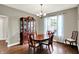 Traditional dining room featuring a wooden table, china cabinet, and window for a warm and inviting atmosphere at 9653 Cypress Way, Carmel, IN 46032