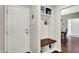 Inviting entryway with a storage bench, coat hooks, and convenient access to the rest of the home at 9653 Cypress Way, Carmel, IN 46032