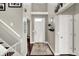 Inviting entryway with hardwood floors, a white front door, and a two-story ceiling at 9653 Cypress Way, Carmel, IN 46032