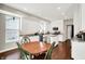 Well-lit kitchen with white cabinets, granite countertops, and stainless steel appliances at 9653 Cypress Way, Carmel, IN 46032