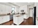 Bright kitchen with modern appliances, granite countertops, and white cabinetry at 9653 Cypress Way, Carmel, IN 46032