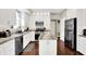 Contemporary kitchen with stainless steel appliances, granite countertops, and ample storage at 9653 Cypress Way, Carmel, IN 46032