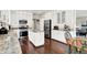 Modern kitchen featuring an island, stainless steel appliances, and adjacent living area at 9653 Cypress Way, Carmel, IN 46032