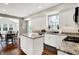 Open kitchen featuring a dining area, granite countertops, stainless appliances and white cabinets at 9653 Cypress Way, Carmel, IN 46032