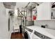 Functional laundry room with a sink, washer, dryer, storage shelves, and utility equipment for home maintenance at 9653 Cypress Way, Carmel, IN 46032