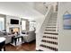 Bright living room boasts a fireplace and staircase to the second floor at 9653 Cypress Way, Carmel, IN 46032