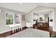 Open concept living area with hardwood floors connecting the kitchen and living spaces at 9653 Cypress Way, Carmel, IN 46032