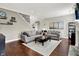 Inviting living room with fireplace, hardwood floors and comfortable seating at 9653 Cypress Way, Carmel, IN 46032