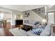 Sunlit living room with hardwood floors, open to dining area and front entry at 9653 Cypress Way, Carmel, IN 46032