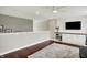 Spacious loft with stylish flooring, a ceiling fan, and a built-in entertainment center with shelving at 9653 Cypress Way, Carmel, IN 46032