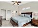 Spacious main bedroom with a comfortable king bed, neutral tones, and ensuite bathroom access for convenience at 9653 Cypress Way, Carmel, IN 46032