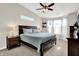 Cozy main bedroom with a king-size bed, ceiling fan, and large windows for natural light and comfort at 9653 Cypress Way, Carmel, IN 46032