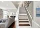 Elegant staircase with white railing and wood stairs, leading to the upper level of the home at 9653 Cypress Way, Carmel, IN 46032