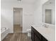 Bright bathroom featuring a vanity with a white countertop, bathtub, and walk-in closet at 10416 Crystal Coop Ln, Indianapolis, IN 46235