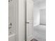 Modern bathroom with a tub-shower combination leading to an adjacent carpeted bedroom at 10416 Crystal Coop Ln, Indianapolis, IN 46235