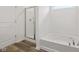 Bathroom showcasing a glass-enclosed shower and a soaking tub at 10416 Crystal Coop Ln, Indianapolis, IN 46235