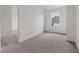 Bright bedroom with neutral carpeting, a window, and a connecting doorway at 10416 Crystal Coop Ln, Indianapolis, IN 46235