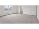Spacious carpeted bedroom with ample natural light and a doorway at 10416 Crystal Coop Ln, Indianapolis, IN 46235
