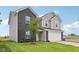 New two-story home with black brick, gray siding, and attached garage at 10416 Crystal Coop Ln, Indianapolis, IN 46235